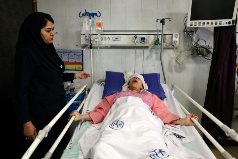 Une Iranienne blessée par une frappe israélienne soignée à l'hôpital Rasoul Akram de Téhéran, le 21 juin 2025 ( AFP / ATTA KENARE )
