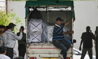 Un camion chargé de cercueils de victimes arrive à la morgue du complexe hospitalier d'Ahmedabad, le 14 juin 2025, après le crash du vol 171 d'Air India dans un quartier résidentiel près de l'aéroport le 12 juin 2025 ( AFP / Punit PARANJPE )