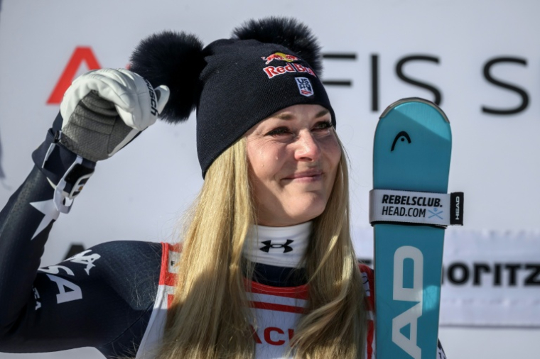 Lindsey Vonn pleure de joie sur le podium après sa victoire dans la descente de St Moritz, le 12 décembre 2025 ( AFP / Fabrice COFFRINI )
