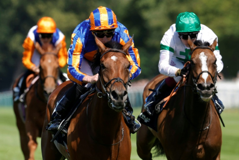 Le jockey anglais Ryan-Lee Moore (c) mène la pouliche Diamond Necklace à la victoire devant le jockey irlandais Oisin Murphy sur Inis Mor (d), lors de la 177e édition du Prix de Diane à Chantilly, le 14 juin 2026 dans l'Oise ( AFP / GEOFFROY VAN DER HASSELT )
