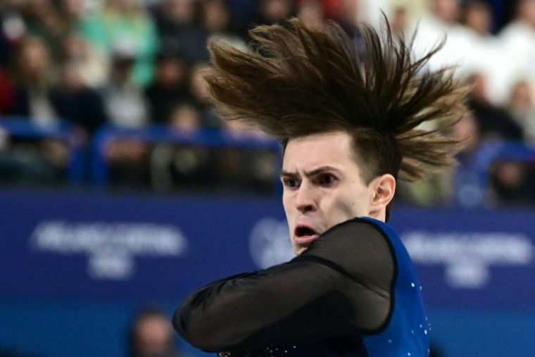 Mikhail Shaidorov lors de son programme libre de patinage artistique le 13 février 2026 sur la patinoire de Milanoù le Kazakhstanais a été sacré champion olympique au terme d'une soirée où le favori américain Ilia Malinin est passé au travers ( AFP / Piero CRUCIATTI )