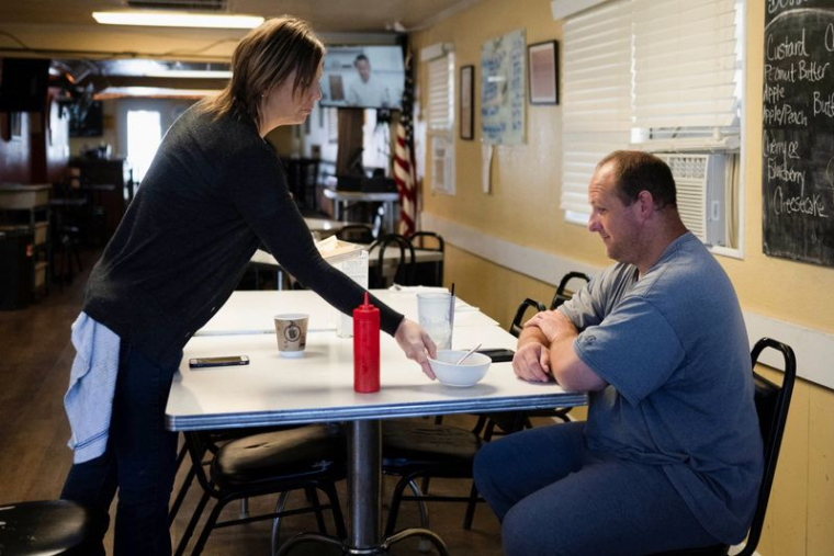 Une serveuse sert un client chez Pete's, un restaurant de barbecue à Smith Center, Kansas