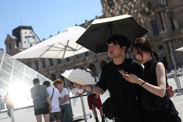 Deux personnes s'abritent lors de la canicule à Paris