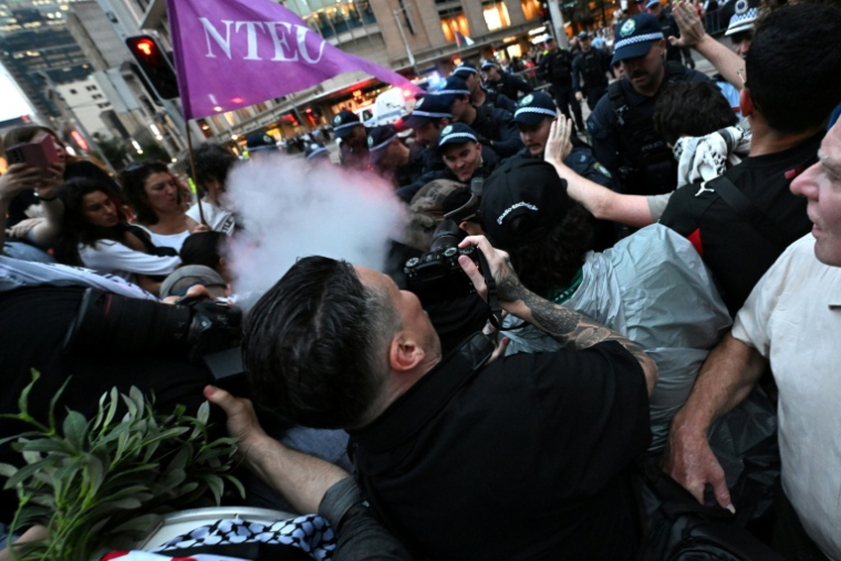 Des policiers utilisent du gaz au  poivre pour disperser des manifestants pro-palestiniens lors d'un rassemblement contre la visite du président israélien Isaac Herzog en Australie, le 9 février 2026 à Sydney ( AFP / Saeed Khan )