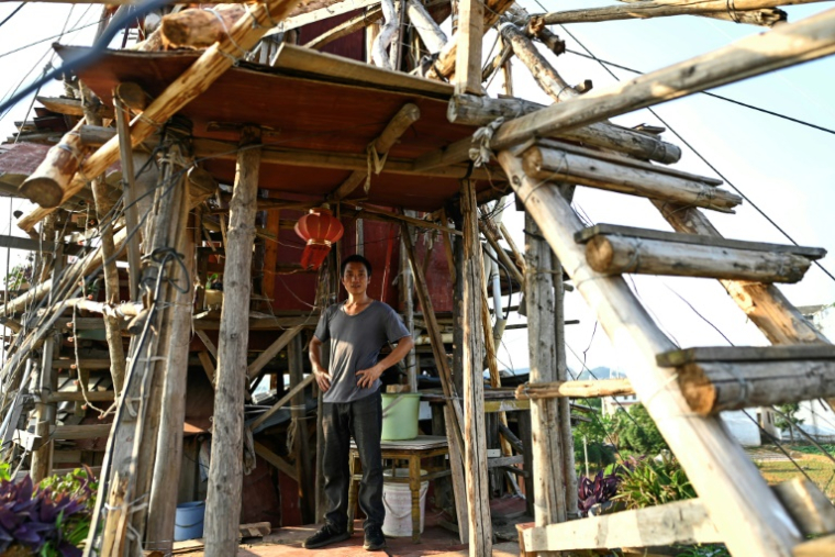 Chen Tianming dans sa "maison clou" à Xingyi, dans la province du Guizhou, le 20 mai 2025 au sud-ouest de la Chine ( AFP / Pedro PARDO )