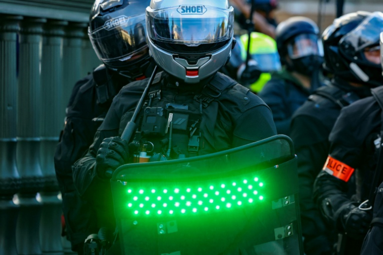 Un policier de la Brav-M muni d'un bouclier stroboscopique lors d'une manifesfation lycéenne place de la Bastille à Paris, le 8 octobre 2026 ( AFP / Kenzo TRIBOUILLARD )