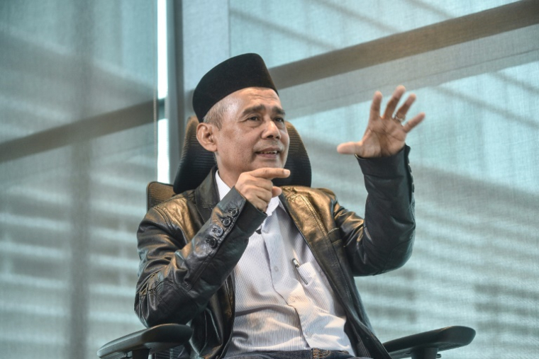 Nikmatullah Seri, porte-parole de la délégation du Barisan Revolusi Nasional (BRN) chargée des négociations de paix avec les autorités thaïlandaises, lors d'un entretien avec l'AFP à Kuala Lumpur, le 14 septembre 2026 ( AFP / Arif Kartono )