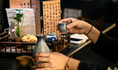 Helen Zhao tient un cocktail inspiré  de la médecine traditionnelle chinoise dans un bar à Shanghai, le 3 février 2026 en Chine ( AFP / Jade GAO )