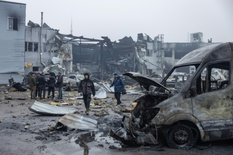 Des habitants inspectent des voitures endommagées après une attaque russe, à Odessa dans le sud de l'Ukraine le 13 février 2026 ( AFP / Oleksandr GIMANOV )