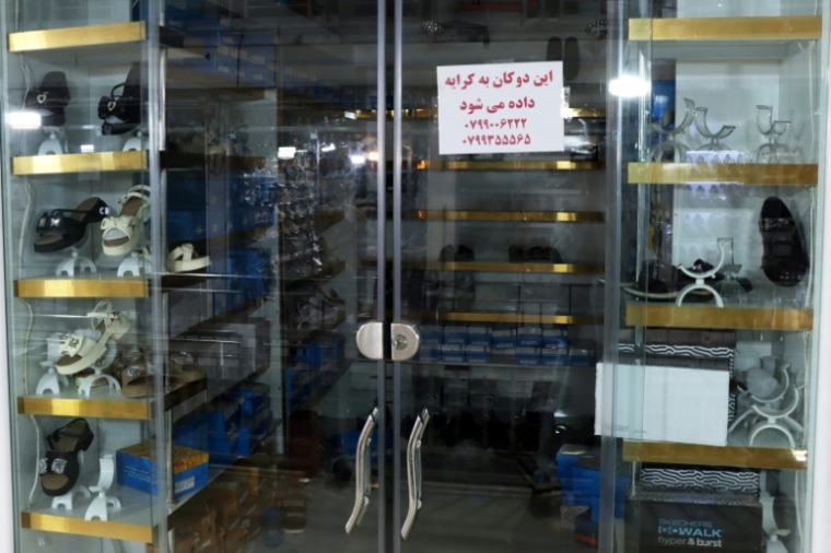 Une affichette indique que le commerce est à vendre, le 30 juin 2026 à Hérat, dans l'ouest de l'Afghanistan  ( AFP / Mohsen KARIMI )