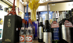 Chinese spirit Baijiu are displayed next to bottles of wine inside a liquor store in Beijing