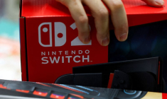 Une personne tient une boîte de console de jeu Nintendo Switch 2