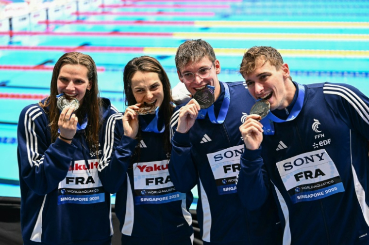 Marie Wattel, Beryl Gastaldello, Yann Le Goff et Maxime Grousset (de gauche) sur le podium du 4x100 m mixte dont ils ont pris la troisième place, derrière les Etats-Unis et la Russie le 2 août 2025 à Singapour ( AFP / MANAN VATSYAYANA )