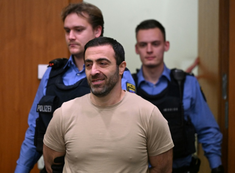 Co-defendant Armenian identified as Vardges I., is led into the courtroom  ( POOL / STF )