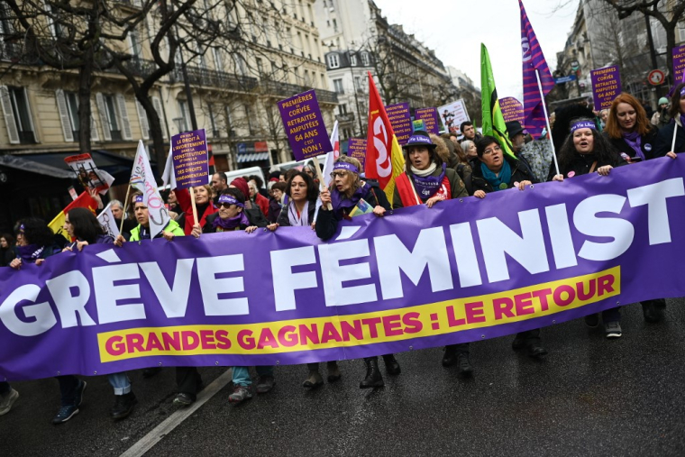 Des femmes défilent derrière une banderole indiquant "Grève féministe" lors d'un rassemblement pour marquer la Journée internationale des droits des femmes à Paris, le 8 mars 2023. ( AFP / CHRISTOPHE ARCHAMBAULT )