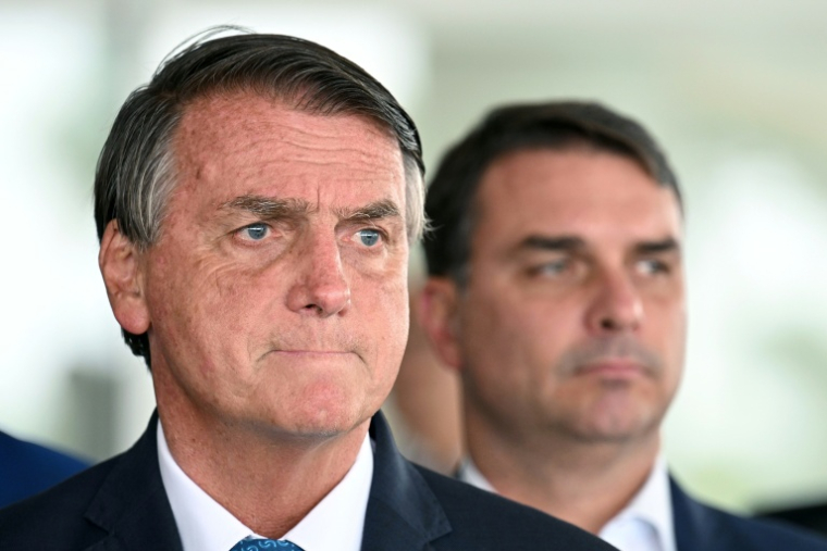 L'ancien président brésilien Jair Bolsonaro avec à sa droite son fils Flavio, aujourd'hui candidat à la présidentielle, le 4 octobre 2022 à Brasilia au Brésil ( AFP / EVARISTO SA )