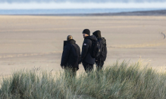Des militants d'extrême droite britanniques surveillent la plage de Gravelines, pour empêcher des migrants de traverser la Manche, le 5 décembre 2025 dans le nord de la France ( AFP / Sameer Al-DOUMY )