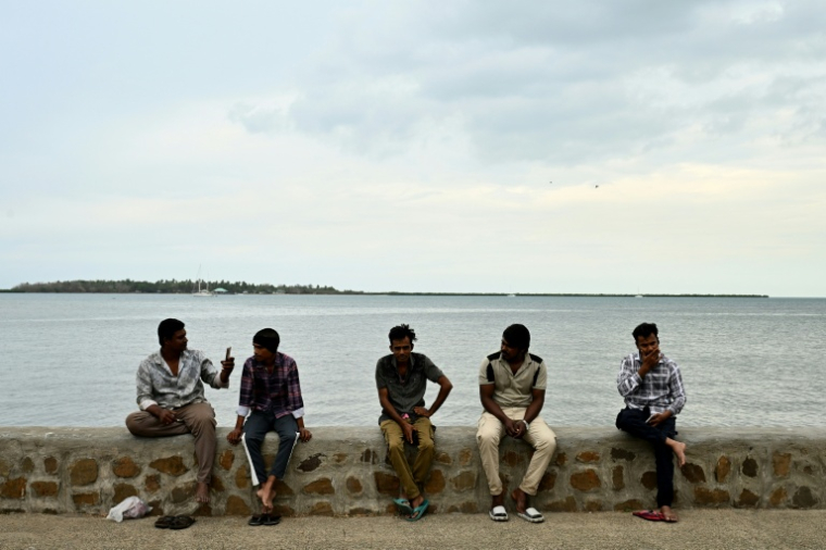 Residents spend their morning on a beach next to the port in Nadi on October 4, 2026, ahead of the Pacific Pre-COP31 Summit's opening ceremony. ( AFP / SAEED KHAN )