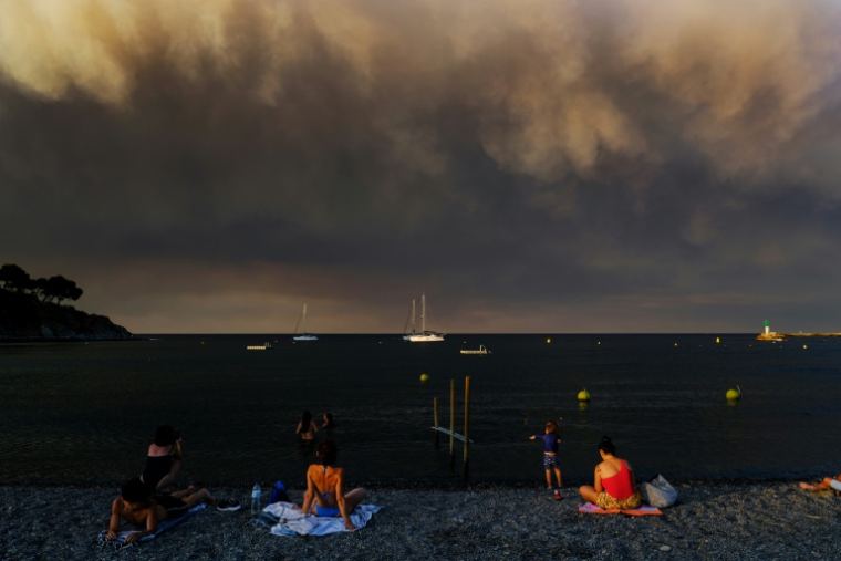 Des nuages de fumée provenant de l'incendie dans l'Aude visibles depuis la plage à Banyuls-sur-Mer (Pyrénées-Orientales), le 5 août 2025 ( AFP / OLIVIER CHASSIGNOLE )