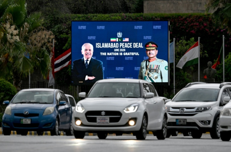 Cars drive past an electronic billboard featuring Pakistani Prime Minister Shehbaz Sharif (left) and army chief and Field Marshal Syed Asim Munir, praising their mediating role in the conflict between Iran and the United States, in Islamabad, June 17, 2026 (AFP / Aamir QURESHI)