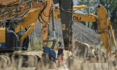 Un ouvrier se tient à côté de pelles mécaniques sur le chantier de l'autoroute A69 près de Verfeil, dans le Tarn-et-Garonne, le 17 juin 2025 ( AFP / Ed JONES )