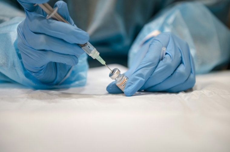 Une infirmière prépare une dose de vaccin Pfizer-BioNTech contre le Covid-19, le 24 novembre 2021 à Montréal (Canada) ( AFP / Andrej Ivanov )