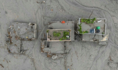 Vue aérienne de maisons recouvertes de boue après la crue destructrice qui a fait plus de 600 morts à la frontière entre le Népal et la Chine, le 29 août 2026 à Devighat, dans le district népalais de Nuwakot ( AFP / Manan VATSYAYANA )