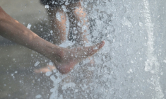 Des gens se rafraîchissent les pieds dans une fontaine de Berlin, le 28 juin 2026  ( AFP / RALF HIRSCHBERGER )