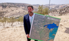 Le ministre israélien des Finances Bezalel Smotrich tient une carte à l'extérieur de Jérusalem, en Cisjordanie occupée, le 14 août 2025 ( AFP / Menahem Kahana )