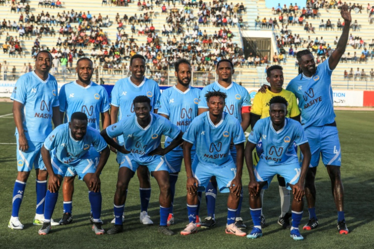 Les anciennes stars du football Jay-Jay Okocha, deuxième à gauche en haut, Samuel Eto'o, troisième à droite en haut, et Emmanuel Adebayor, premier à droite en haut, face au public avant un match de gala à Mogadiscio, capitale de la Somalie, le 27 mai 2025 ( AFP / Hassan Ali Elmi )