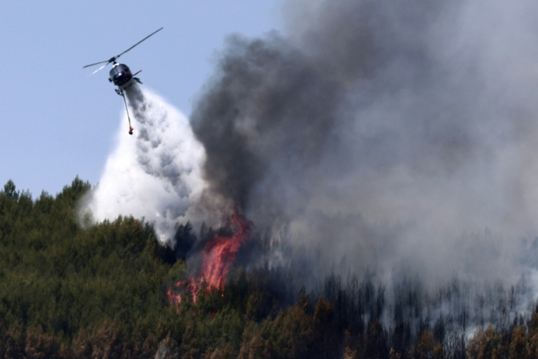 Un hélicoptère Airbus H125 largue de l'eau sur un incendie de forêt à Taradeau, le 20 juillet 2026 dans le Var ( AFP / Thibaud MORITZ )