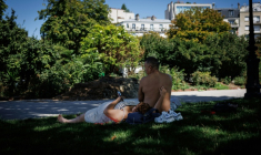 Des personnes sont allongées sur l'herbe à l'ombre place de la Nation, à Paris, le 28 juillet 2026, lors de la quatrième vague de chaleur en France ( AFP / Simon WOHLFAHRT )