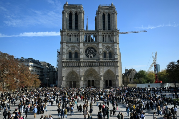 Des visiteurs devant Notre-Dame de Paris, le 11 octobre 2025 ( AFP / Martin LELIEVRE )