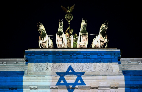 La porte de Brandebourg illuminée aux couleurs du drapeau israélien, le 7 octobre 2026 à Berlin, à l'occasion du troisième anniversaire de l'attaque du Hamas contre Israël ( AFP / Tobias SCHWARZ )