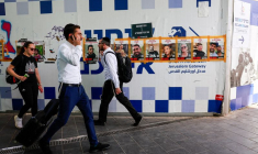 Des personnes passent devant les affiches des otages enlevés lors de l'attaque meurtrière du 7 octobre par le Hamas, à Jérusalem