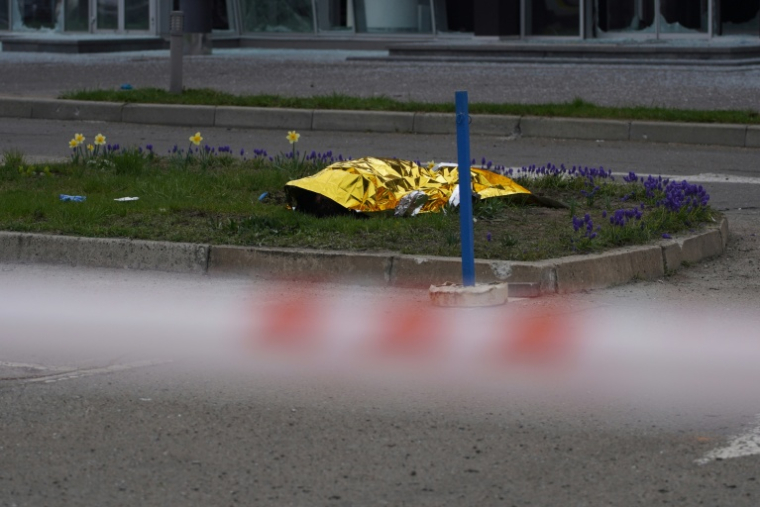 Le corps d'un civil gît au sol, caché par une couverture, après une frappe russe à Kiev, le 16 avril 2026 ( AFP / Serhii Okunev )