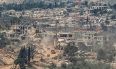 Véhicules militaires israéliens circulant sur la route au milieu de maisons détruites dans le sud du Liban, à la frontière avec Israël, le 27 avril 2026 ( AFP / Jalaa MAREY )