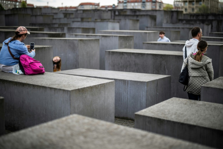 Des visiteurs marchent entre les stèles du Mémorial de l'Holocauste à Berlin, le 14 avril 2025 ( AFP / John MACDOUGALL )