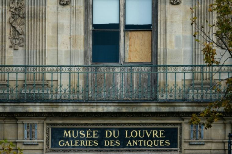 Une fenêtre cassée par laquelle les voleurs sont passés pour dérober au musée du Louvre les joyaux de la Couronne, à Paris le 20 octobre 2025 ( AFP / Dimitar DILKOFF )