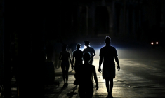 Des habitants marchent dans une rue de La Havane pendant une panne d'électricité, le 13 mai 2026 à Cuba ( AFP / Yamil LAGE )