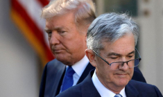 FILE PHOTO: U.S. President Donald Trump looks on as Jerome Powell, his nominee at the time to lead the Fed, moves to the podium at the White House