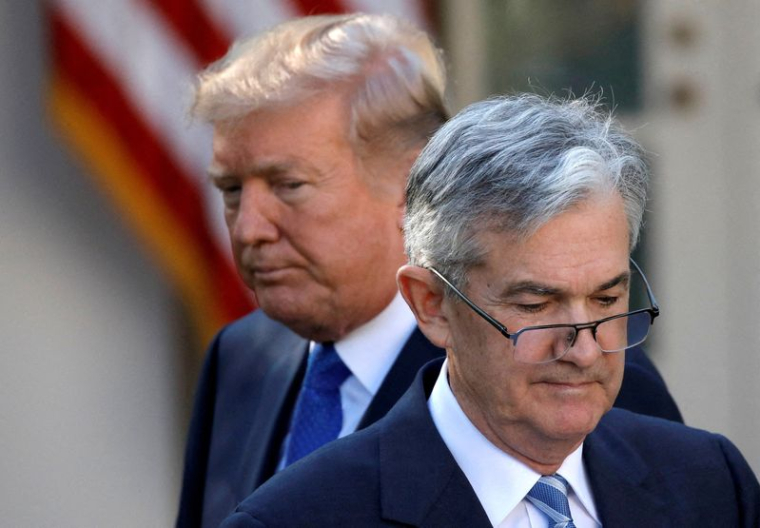 FILE PHOTO: U.S. President Donald Trump looks on as Jerome Powell, his nominee at the time to lead the Fed, moves to the podium at the White House