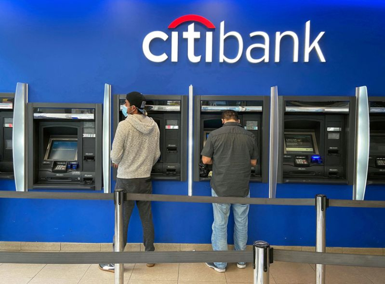 FILE PHOTO: Customers use ATMs at Citibank branch in New York City