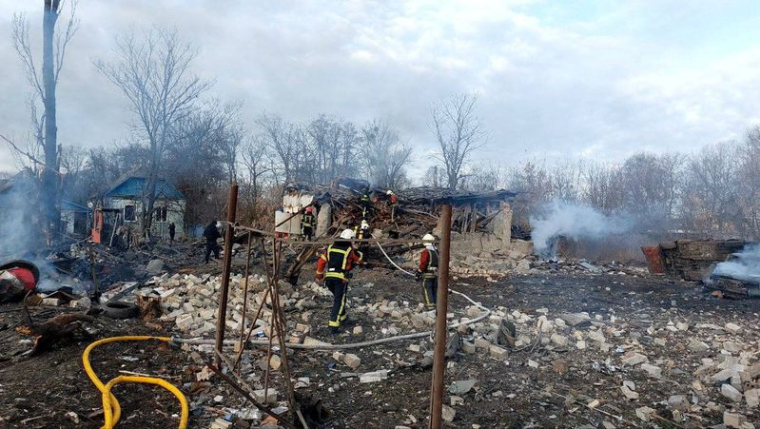Des secouristes travaillent sur un site de maisons endommagées par un tir de missile russe, à Kiev