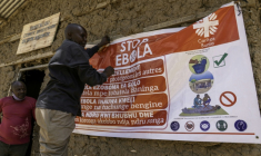 Un homme accroche une affiche de sensibilisation dans la lutte contre le virus Ebola, le 28 mai 2026 à Bunia, dans l'est de la République démocratique du Congo (RDC) ( AFP / Glody MURHABAZI )