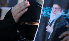 Une femme irakienne chiite se tient la tête en brandissant une photo du guide suprême iranien Ali Khamenei, tué la veille dans une opération israélo-américaine, le 1er mars 2026 à Bagdad ( AFP / AHMAD AL-RUBAYE )