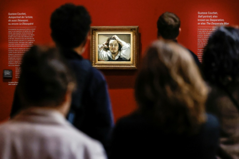 Des visiteurs devant le tableau "Le Désespéré", célèbre autoportrait du peintre français Gustave Courbet, exposé au musée d'Orsay à Paris, le 13 octobre 2025 ( AFP / Ian LANGSDON )