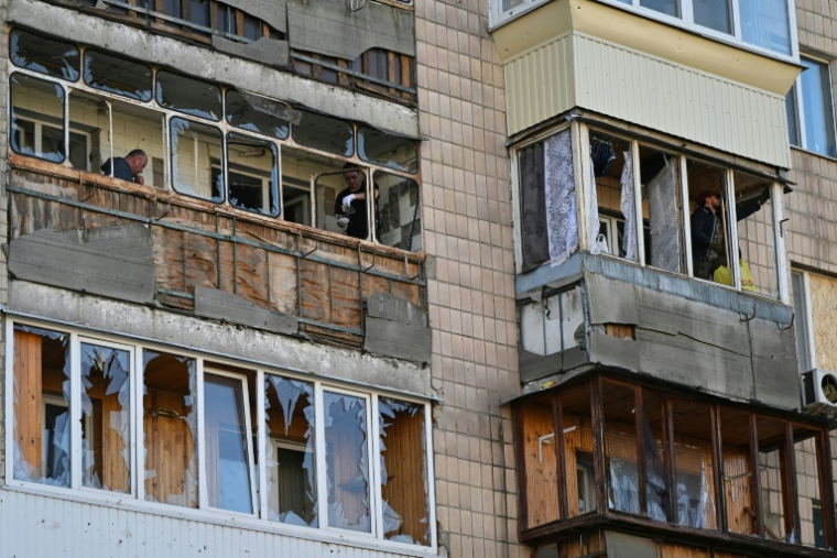 Les vitres d'un immeuble d'habitation soufflées après une attaque de missile et de drone dans la localité ukrainienne de Brovary, près de Kiev, le 14 mars 2026  ( AFP / Genya SAVILOV )
