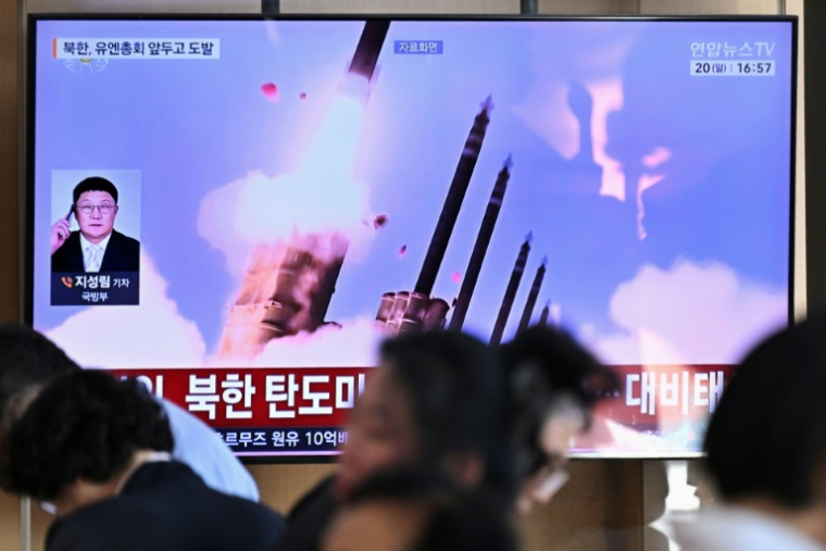 Des personnes sont assises près d'un écran TV diffusant un bulletin d'information avec des images d'archives d'un essai de missile nord-coréen, le 20 septembre 2026 dans une gare de Séoul ( AFP / Lillian SUWANRUMPHA )