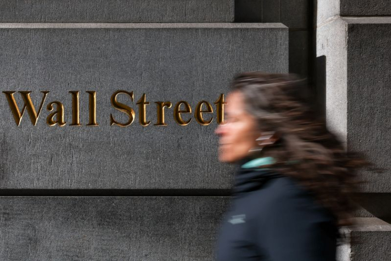 Une femme descend Wall Street à New York, États-Unis